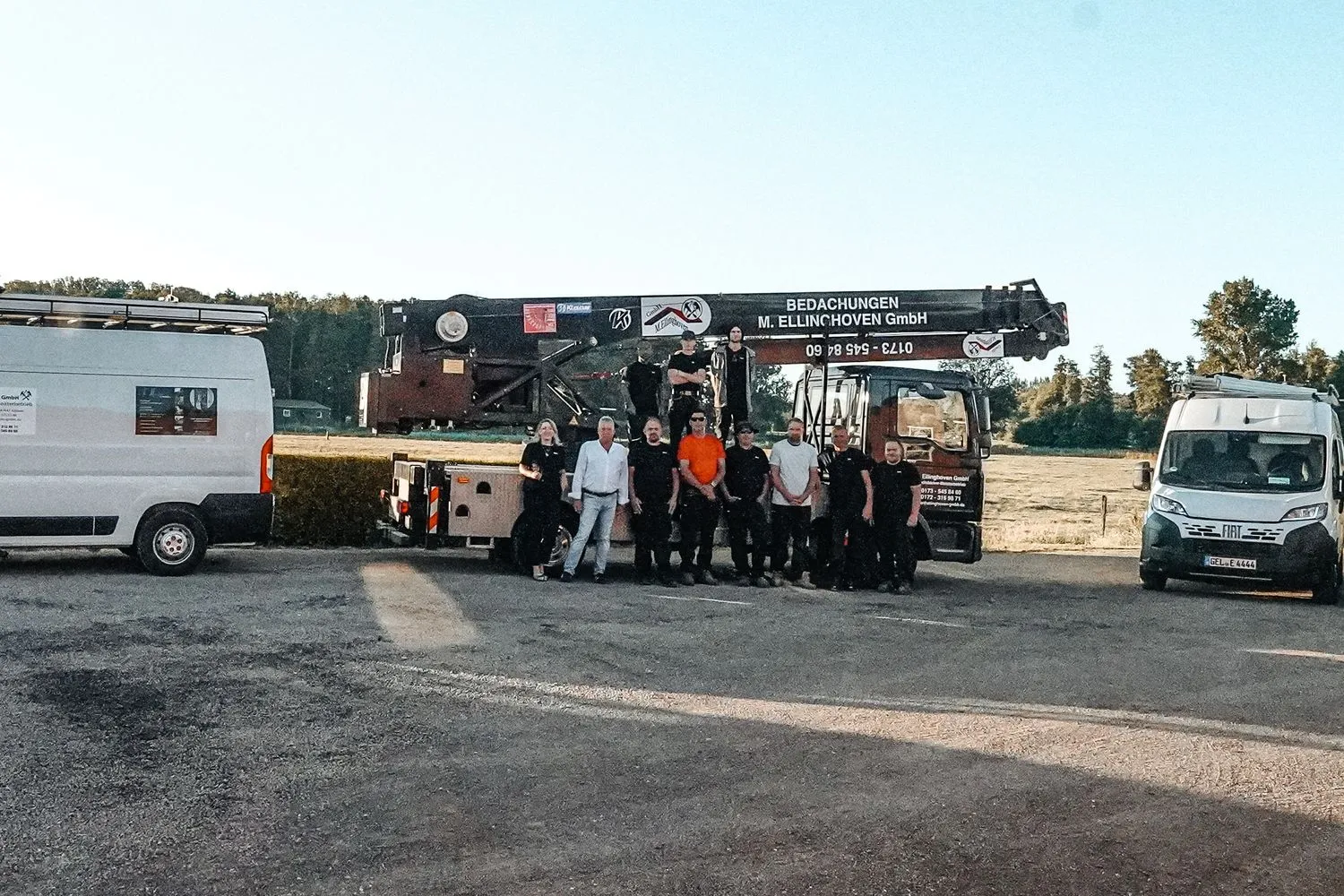 Das Team vor dem Kran-Lkw, links und rechts je ein Transporter